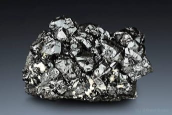 A specimen of cassiterite, the silver-grey ore from which tin is refined.