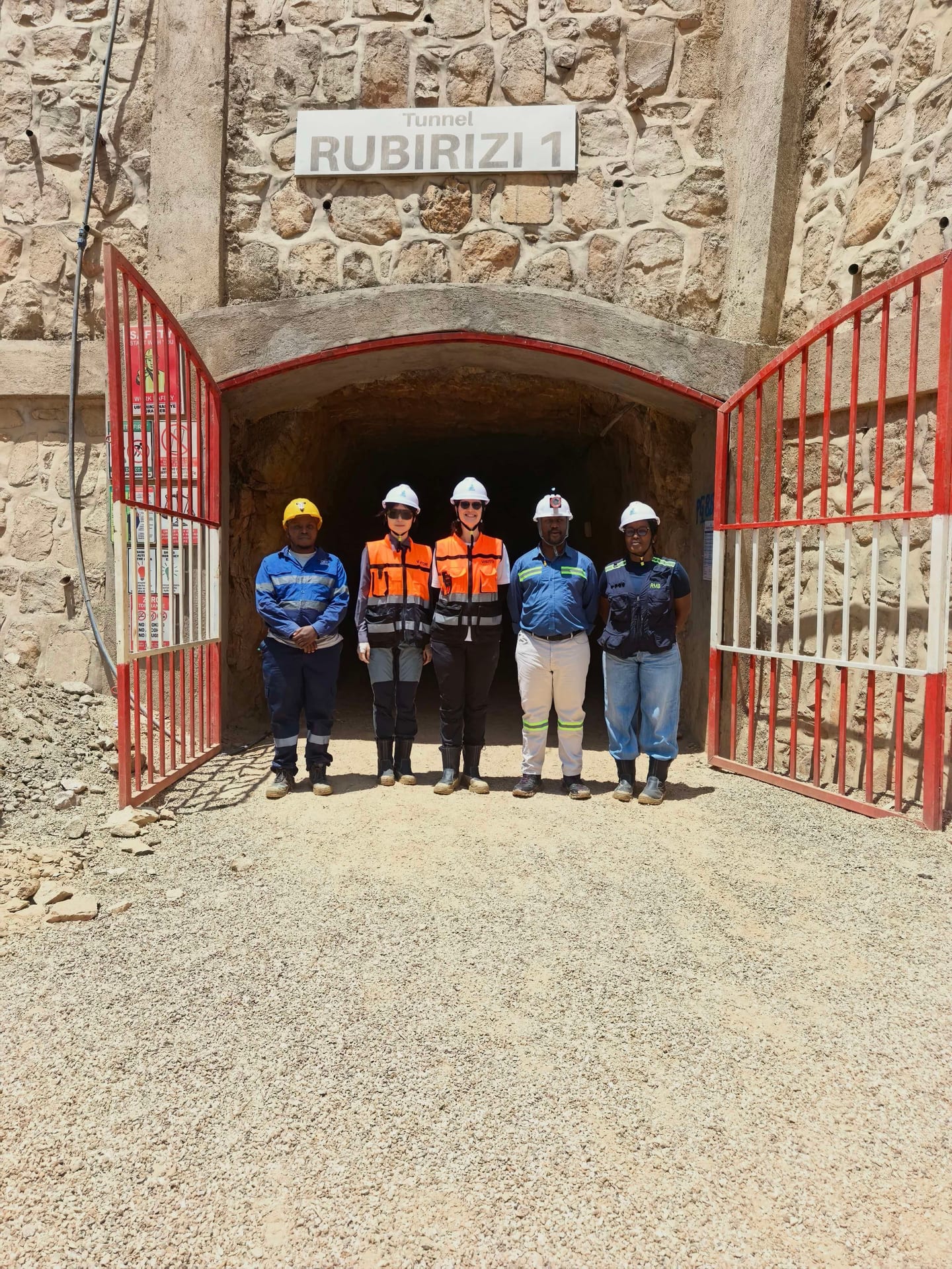 Five colleagues in protective equipment at the entrance to the Rubirizi 1 tunnel.